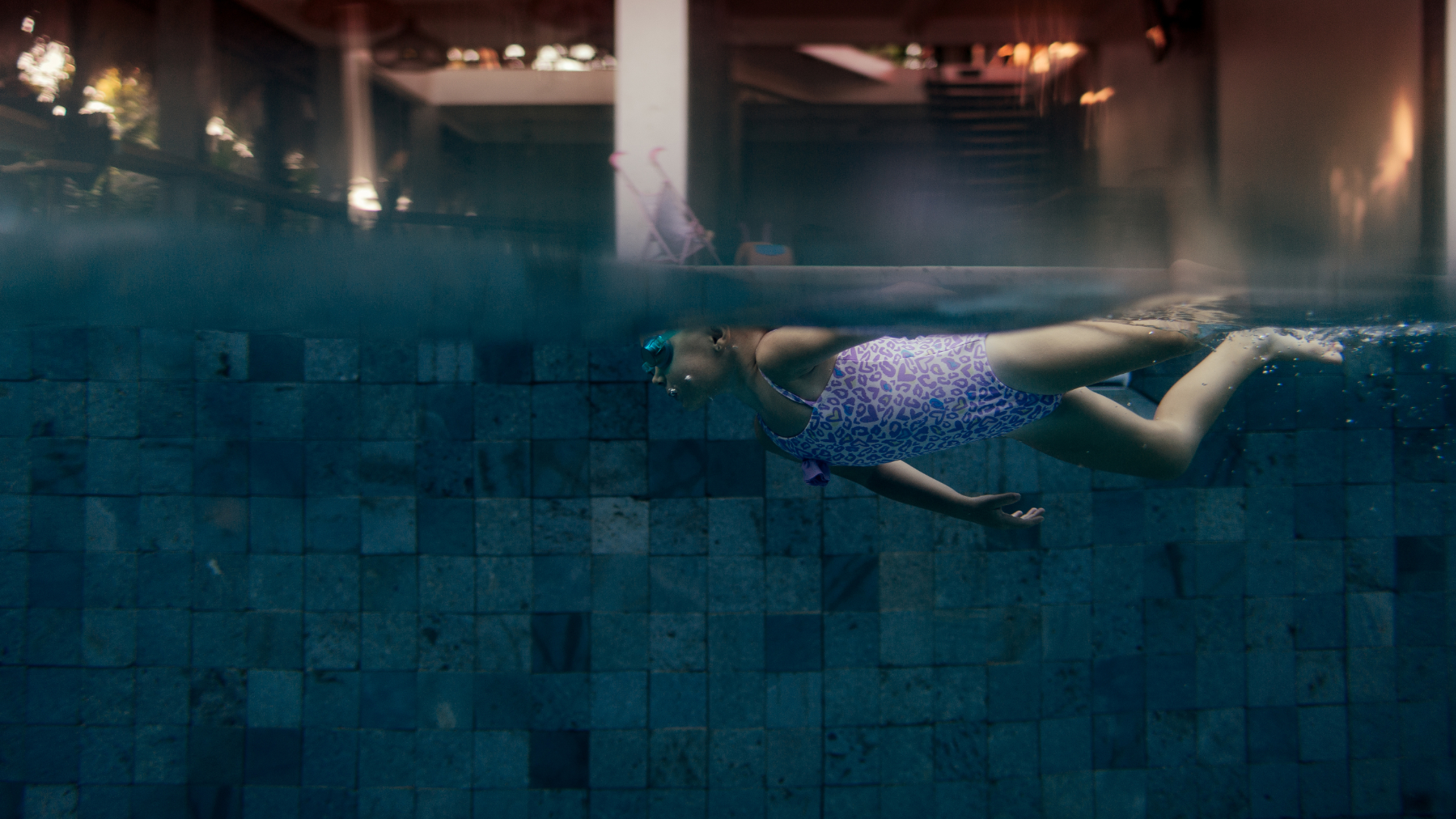 little girl swims in the pool